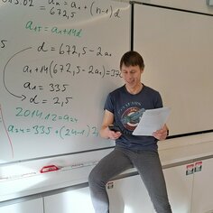 Math teacher infront of the whiteboard.