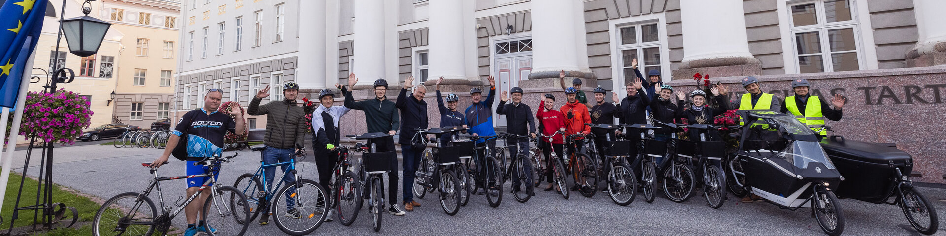 Tartu kõrgkoolide esindajad koos jalgratastega Tartu Ülikooli peahoone ees.